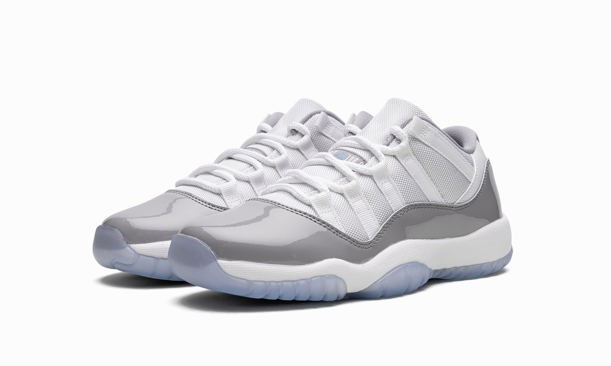 Air Jordan 11 Low GS "Cement Grey" running in a city park shoes