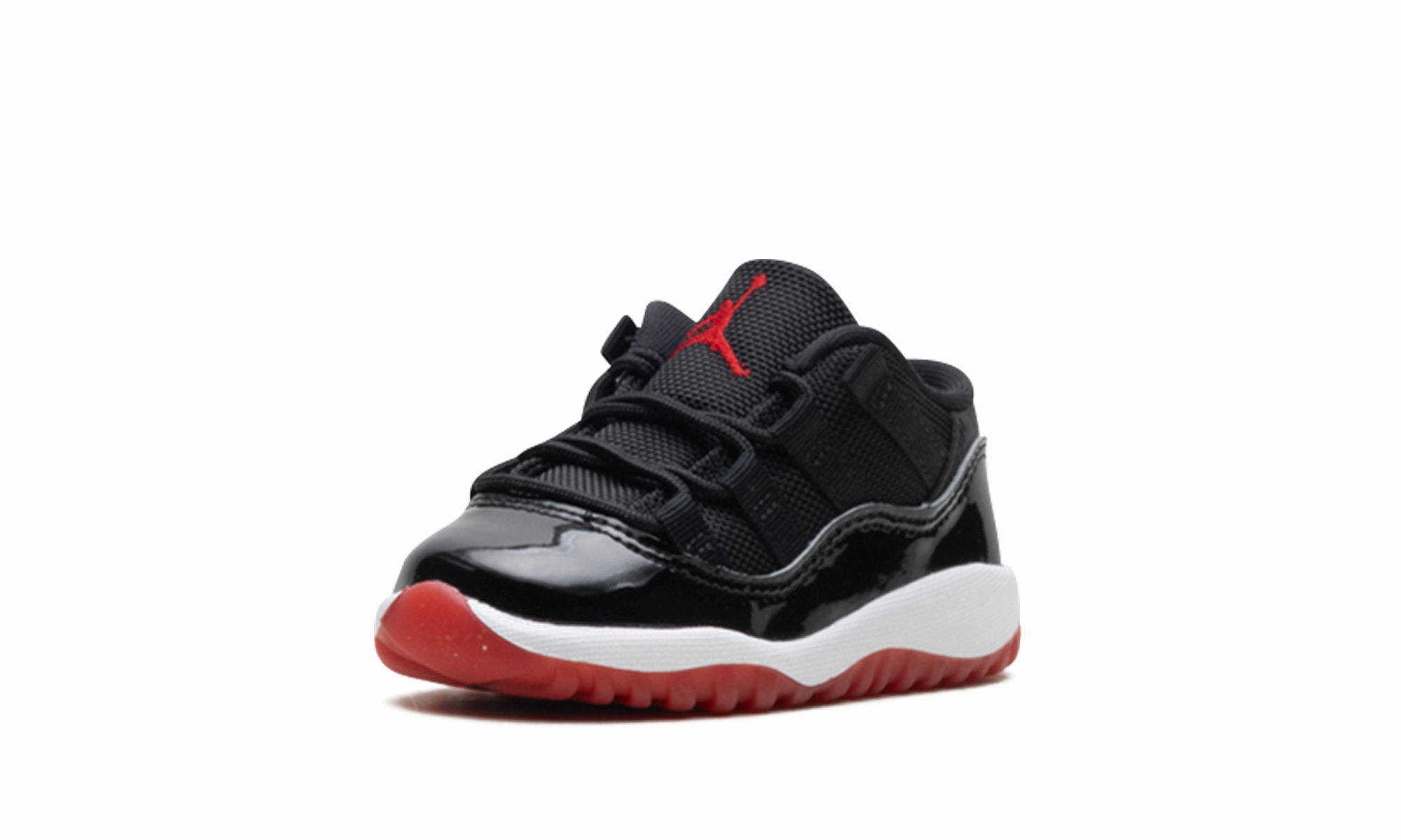 Air Jordan 11 Retro Low TD "Bred" running in a relay race Snowy Terrain