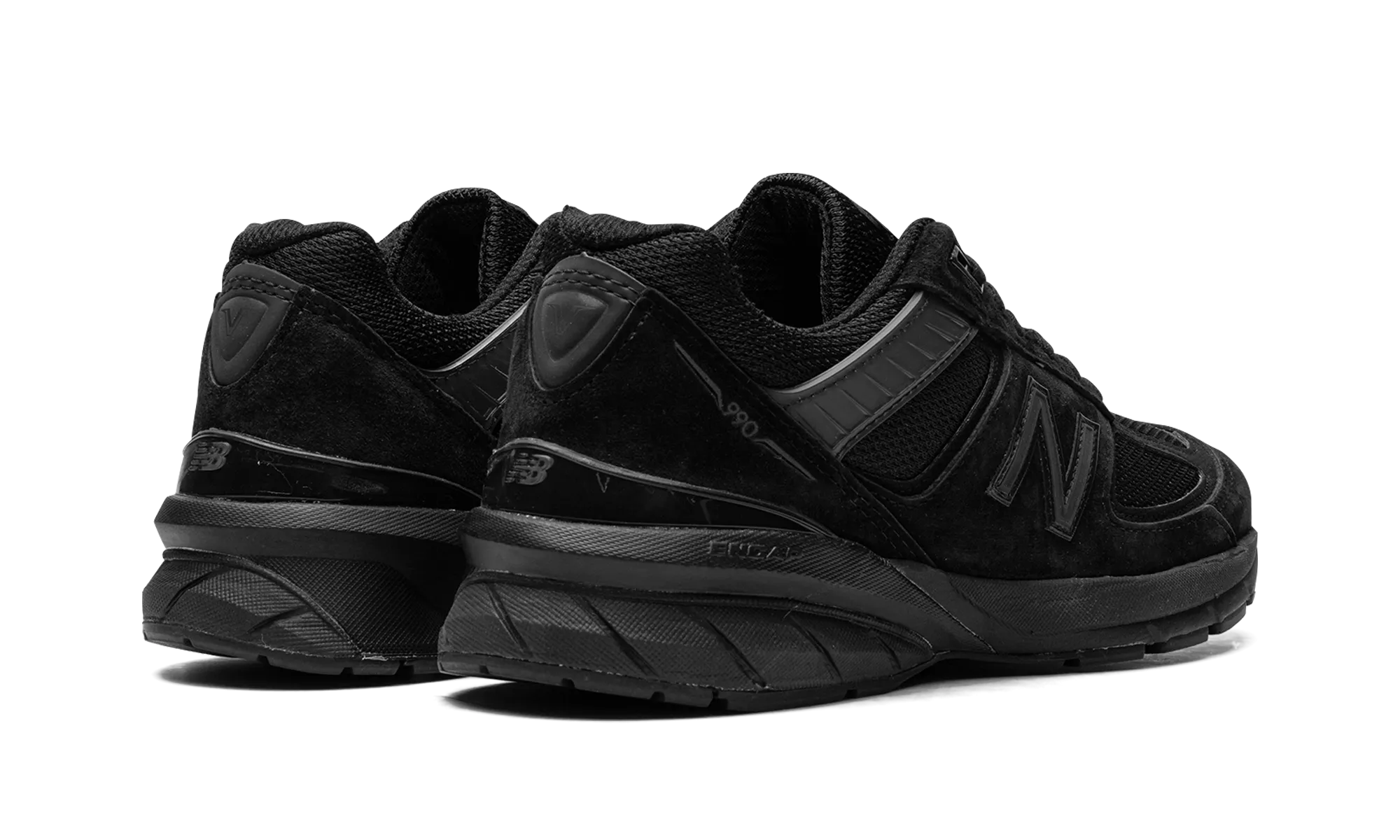 990v5 "Made in USA Triple Black" running in a jungle area shoes