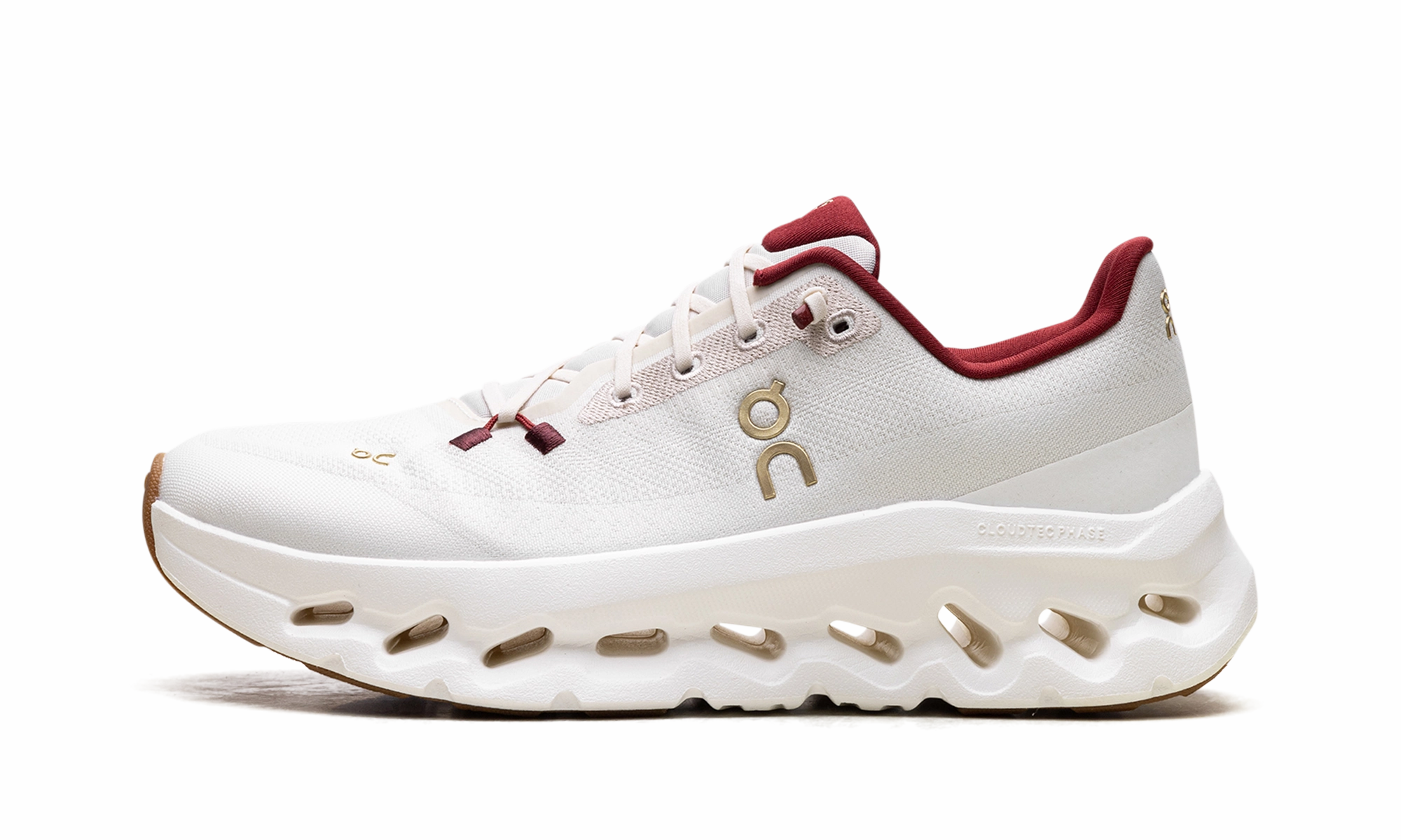 Cloudtilt WMNS "Pearl Ivory" running in a city park shoes