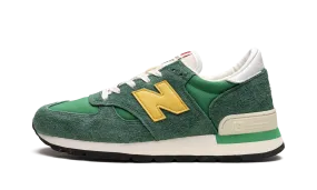 990 V1 "Green/Gold" running in a playground shoes right - foot shoe