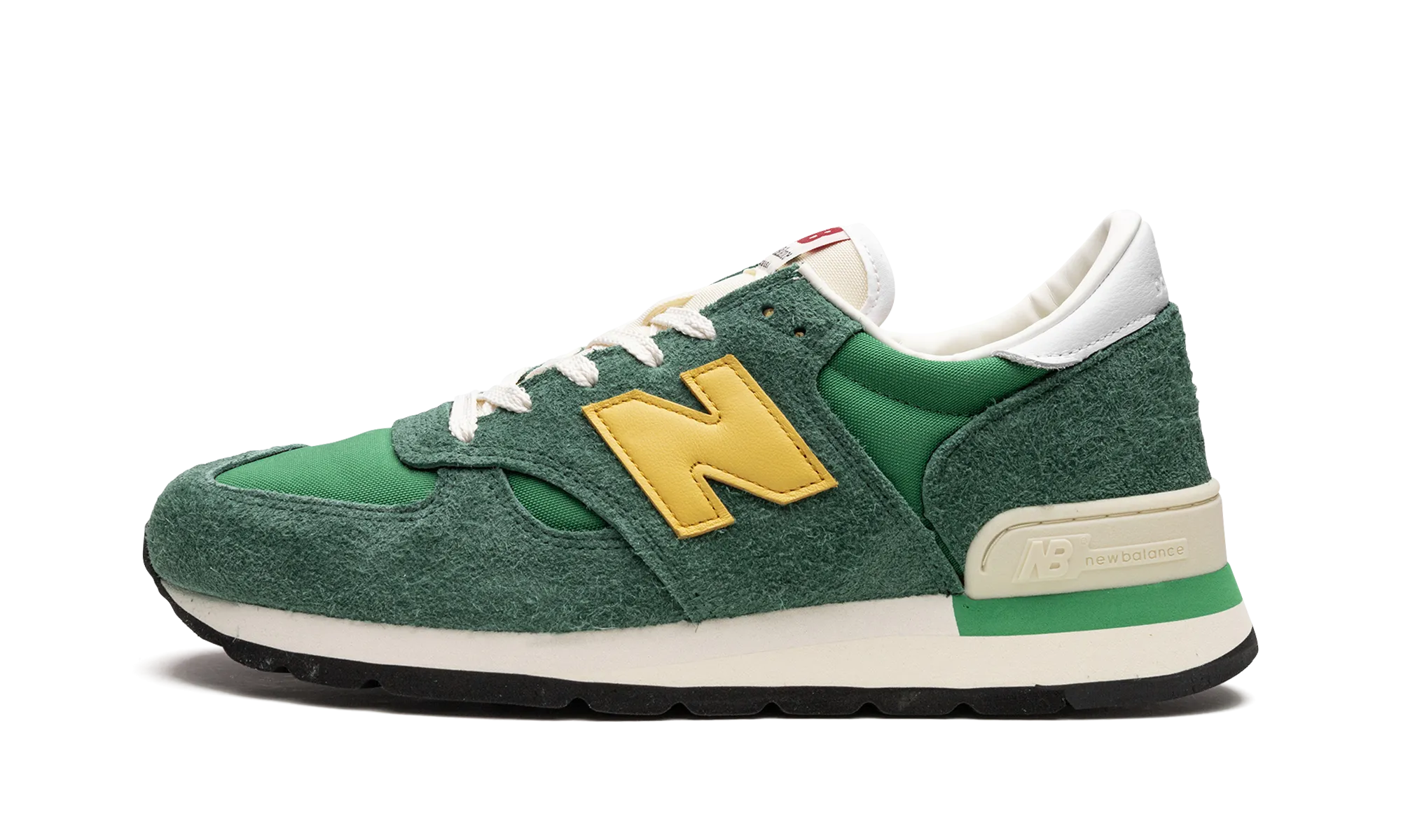 990 V1 "Green/Gold" running in a playground shoes right - foot shoe
