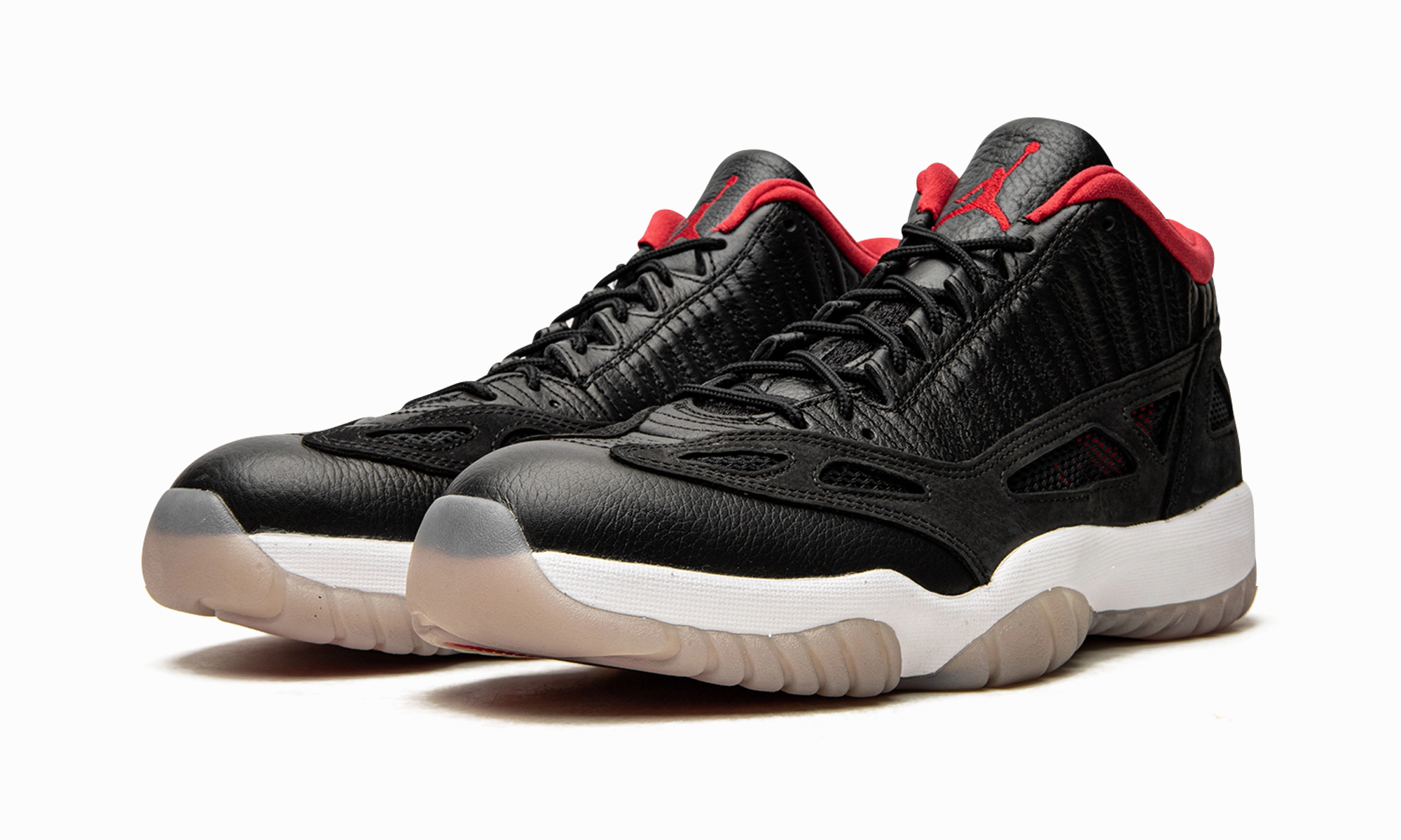 Youth running Air Jordan 11 Low IE "Bred 2021"